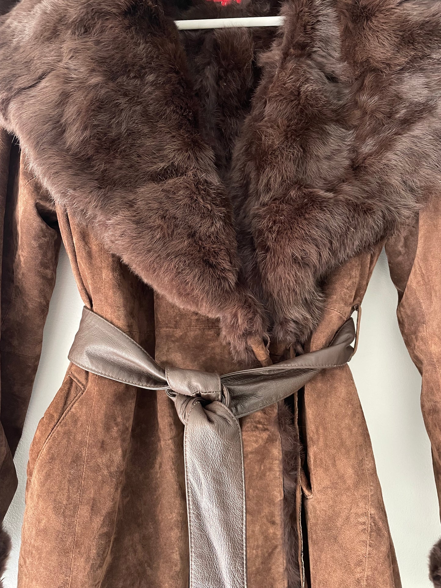 Suede coat with a fur collar.