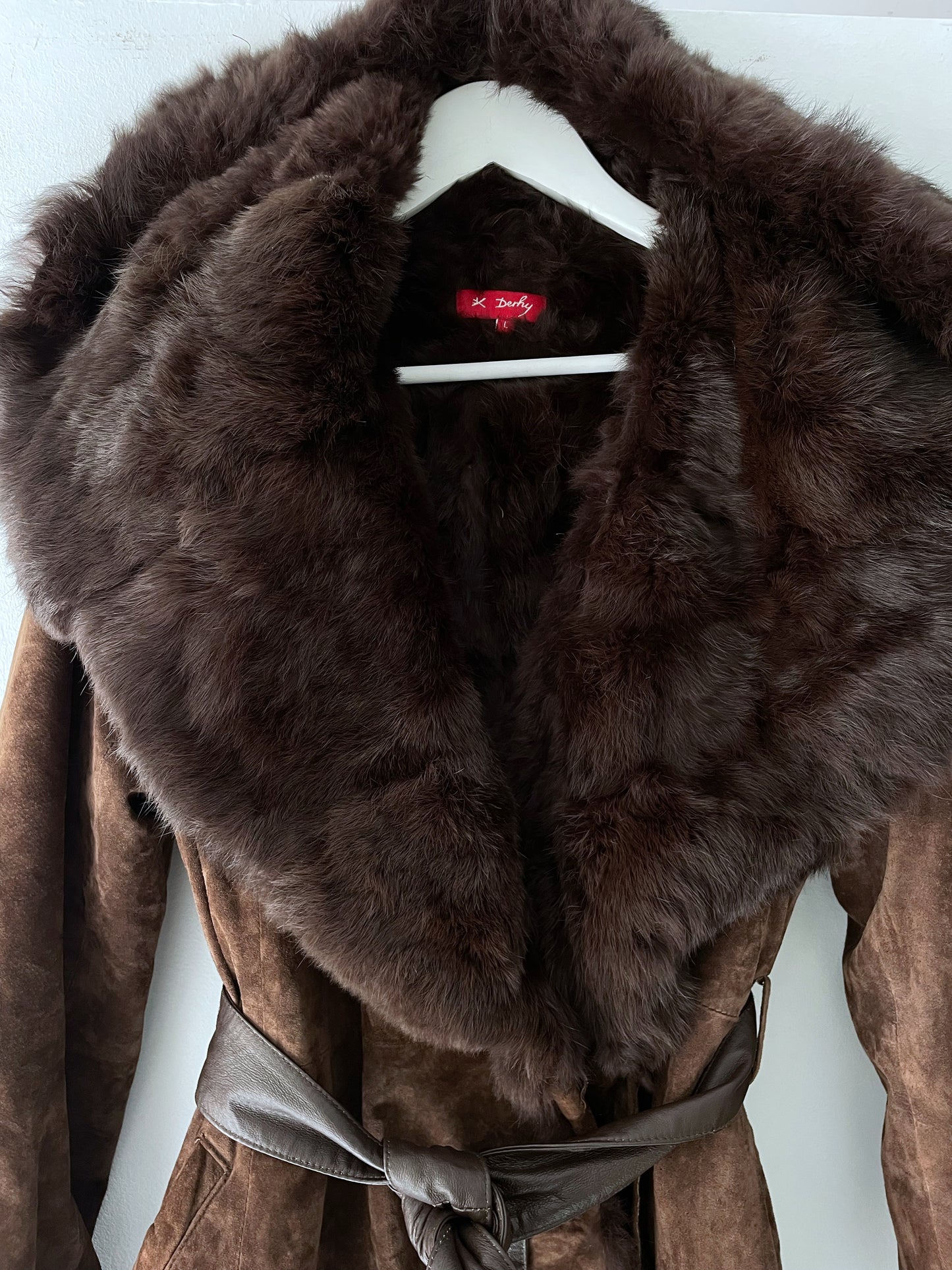 Suede coat with a fur collar.