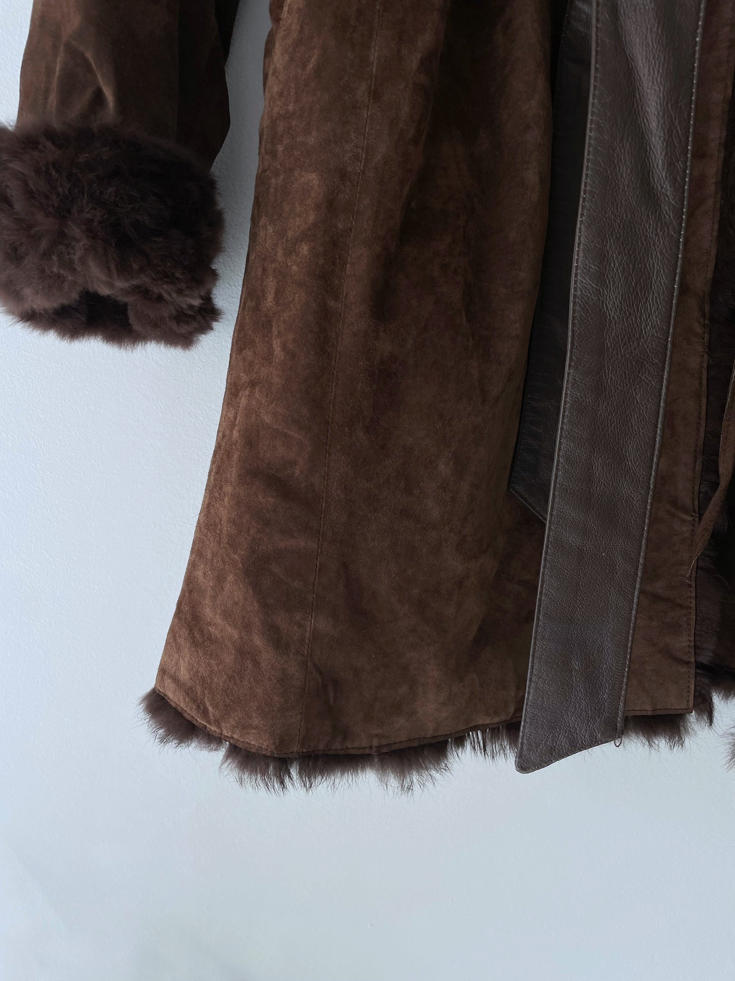 Suede coat with a fur collar.