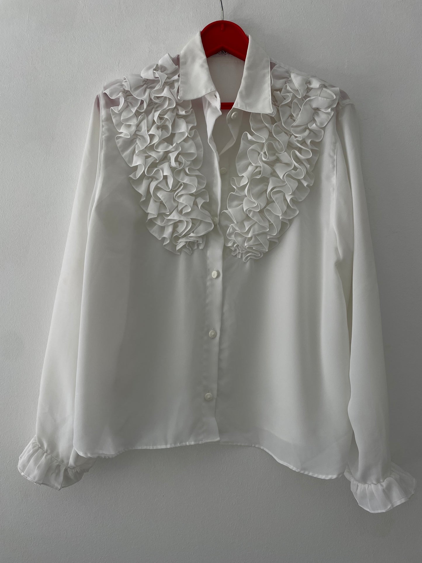 White ruffled blouse.