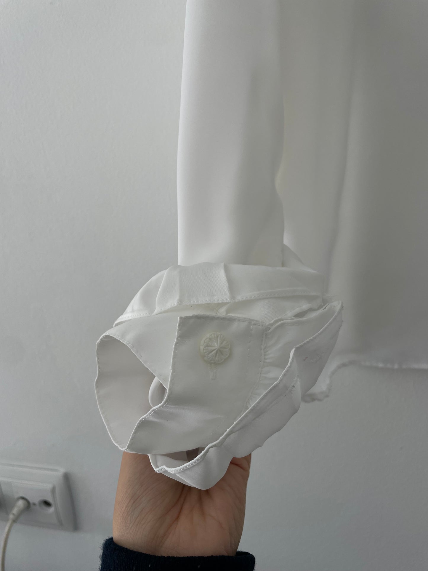 White ruffled blouse.