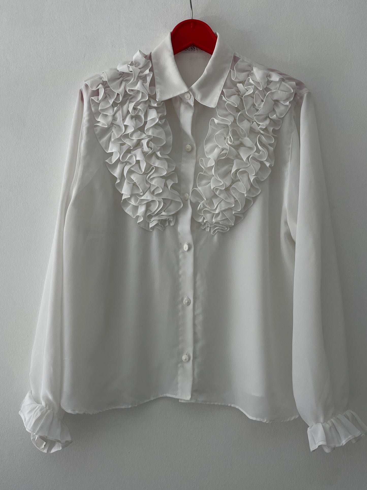 White ruffled blouse.